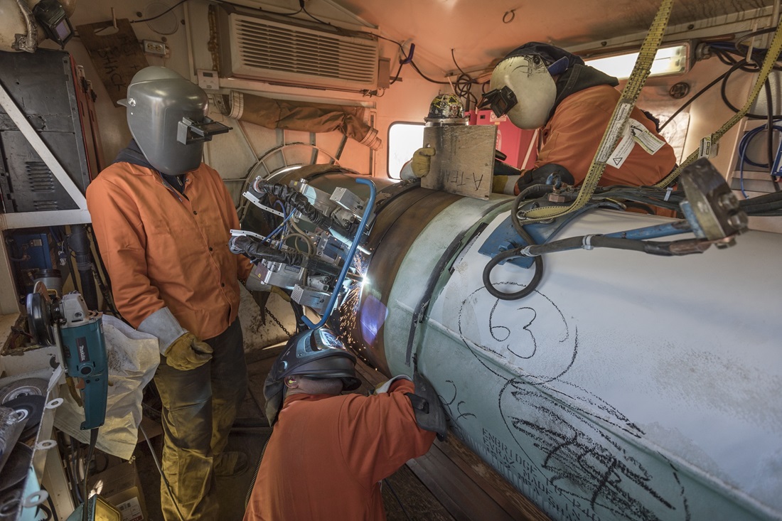 Welders operate automated welding units — one that performs an initial weld from the interior, another (pictured here) that completes the work from the exterior for the Line 3 replacement project. Photograph supplied by Enbridge