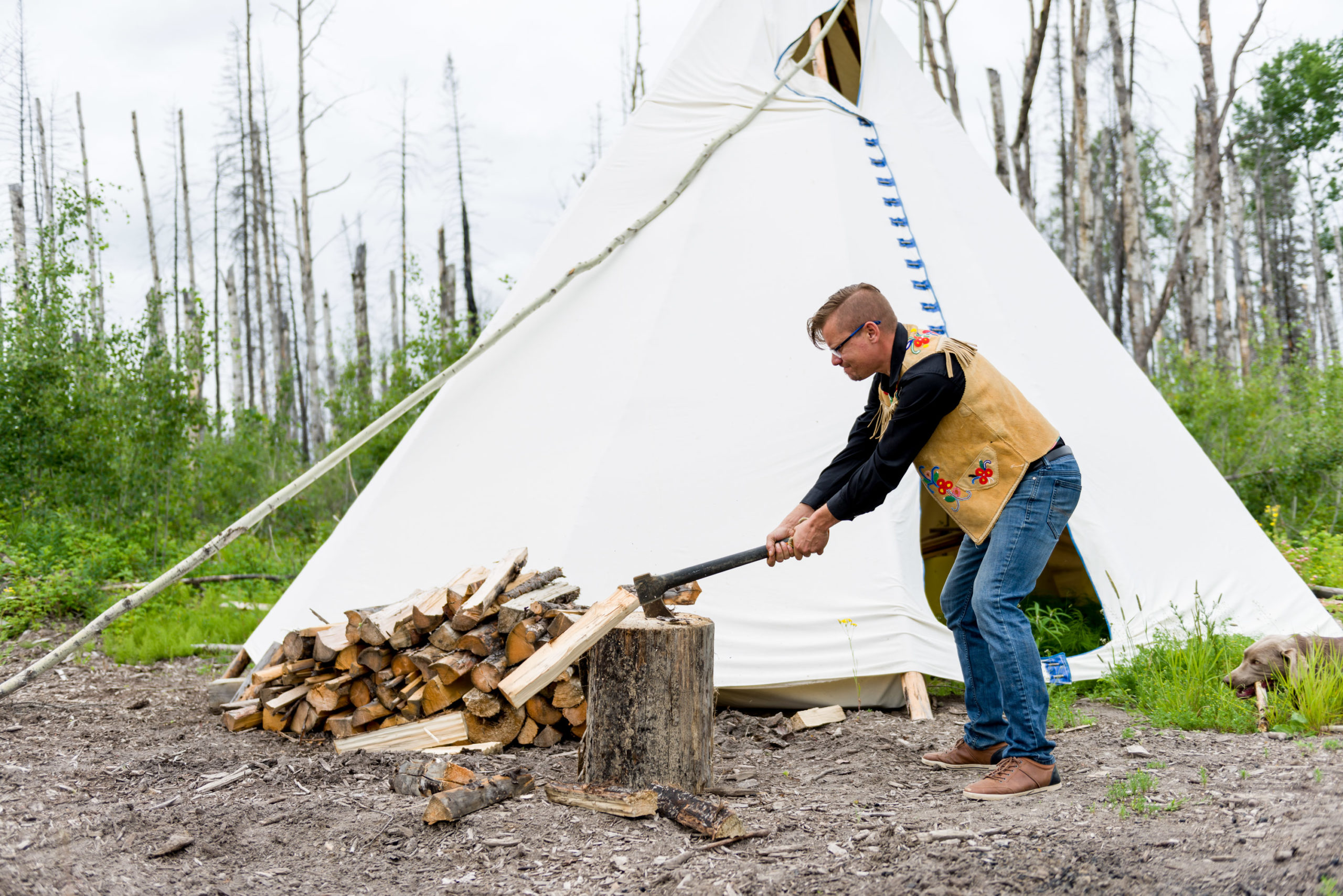 Bourque prepares firewood on his trap line. Photo for Canadian Energy Centre.