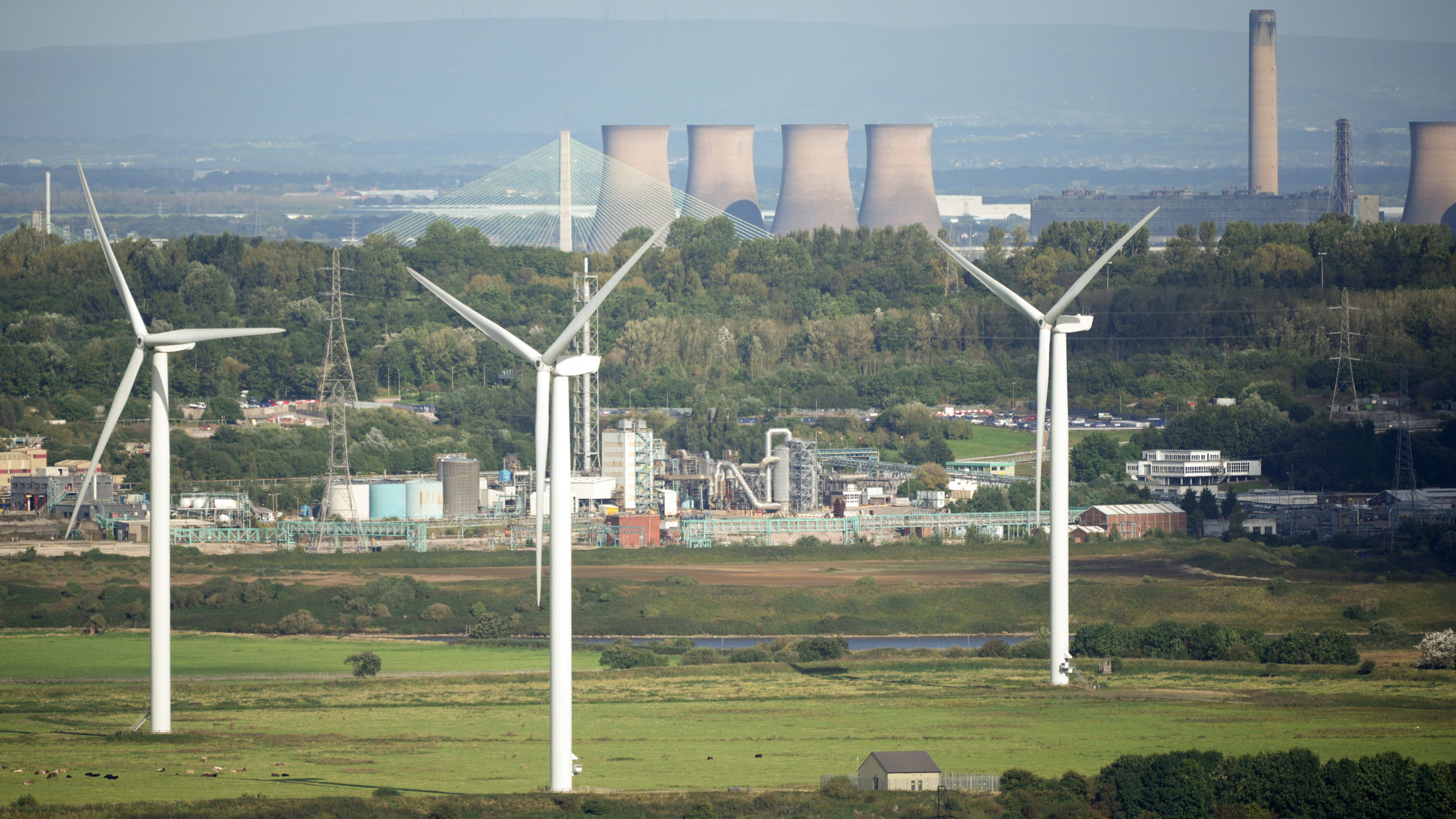 Wind turbines stand in front of the Fiddlers Ferry decommissioned coal fired power station on September 27, 2021 in Runcorn, England. Getty Images photo