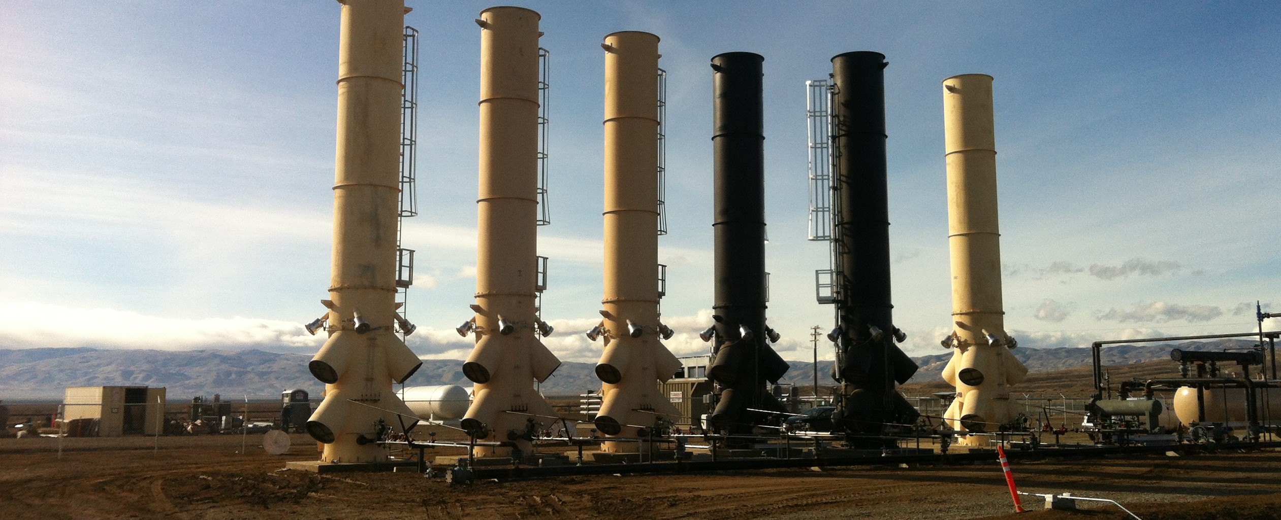 Some of Iconic’s enclosed flare incinerators, which thoroughly combust waste gas. Photograph supplied for Canadian Energy Centre