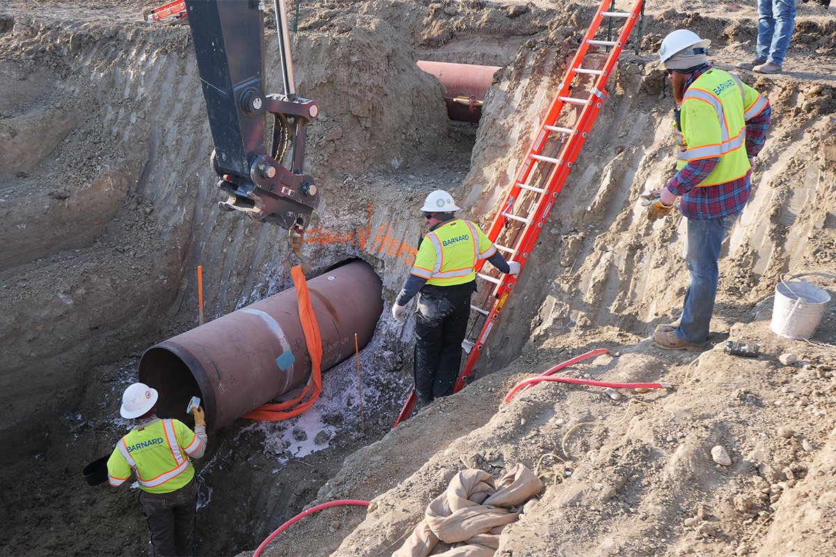 Construction contractors for TC Energy install a section of the Keystone XL crude oil pipeline at the U.S.-Canada border north of Glasgow, Mont. in April 2020. Photograph courtesy TC Energy