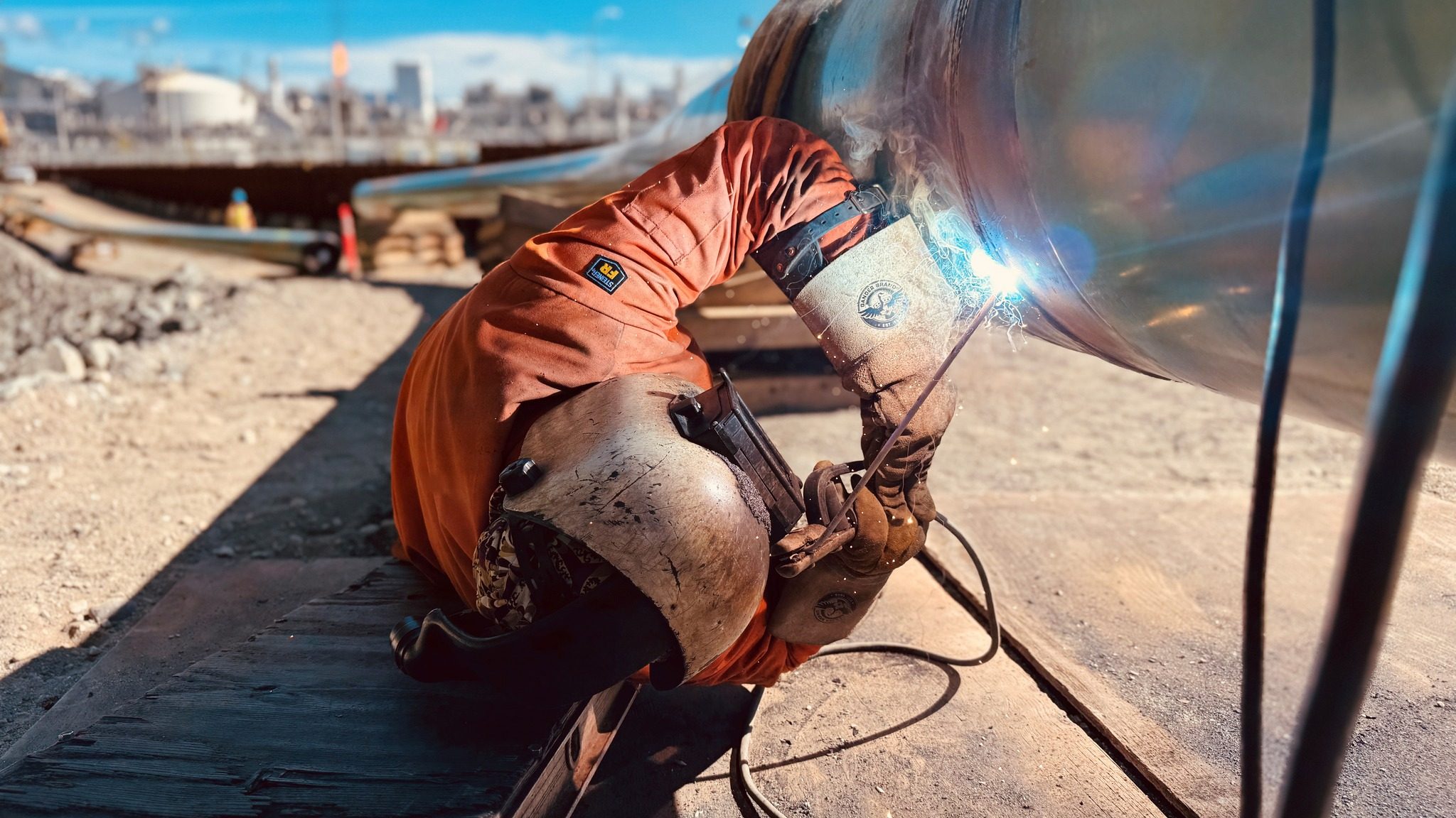 Construction underway on the Cedar LNG pipeline, with the LNG Canada terminal in the background. Photo courtesy Cedar LNG