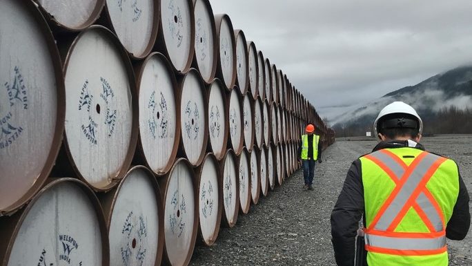 Workers on the Coastal GasLink natural gas pipeline project survey a delivery of pipe. Photograph courtesy TC Energy