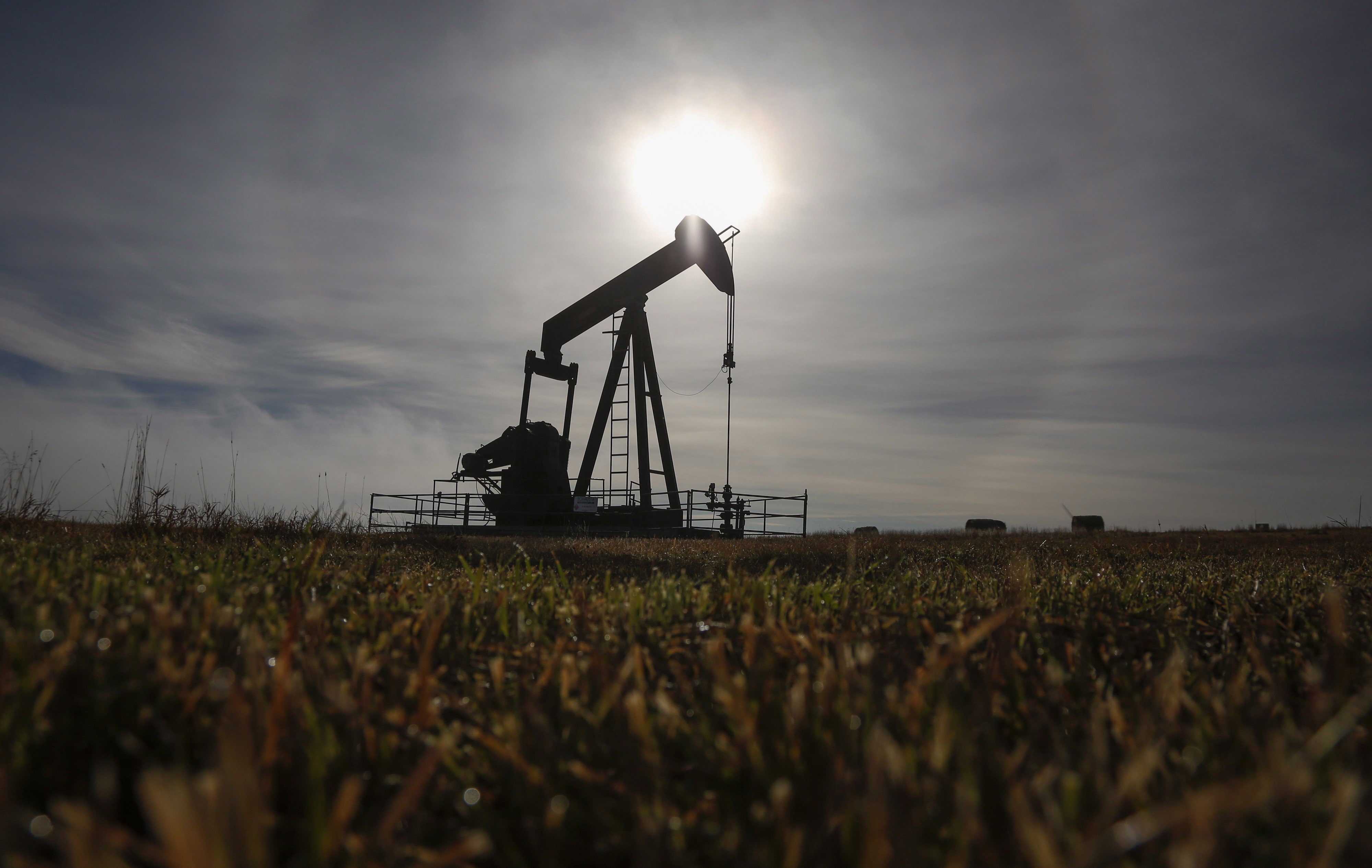 A pumpjack works at a well head on an oil and gas installation near Cremona, Alta., Saturday, Oct. 29, 2016. The Canadian Press