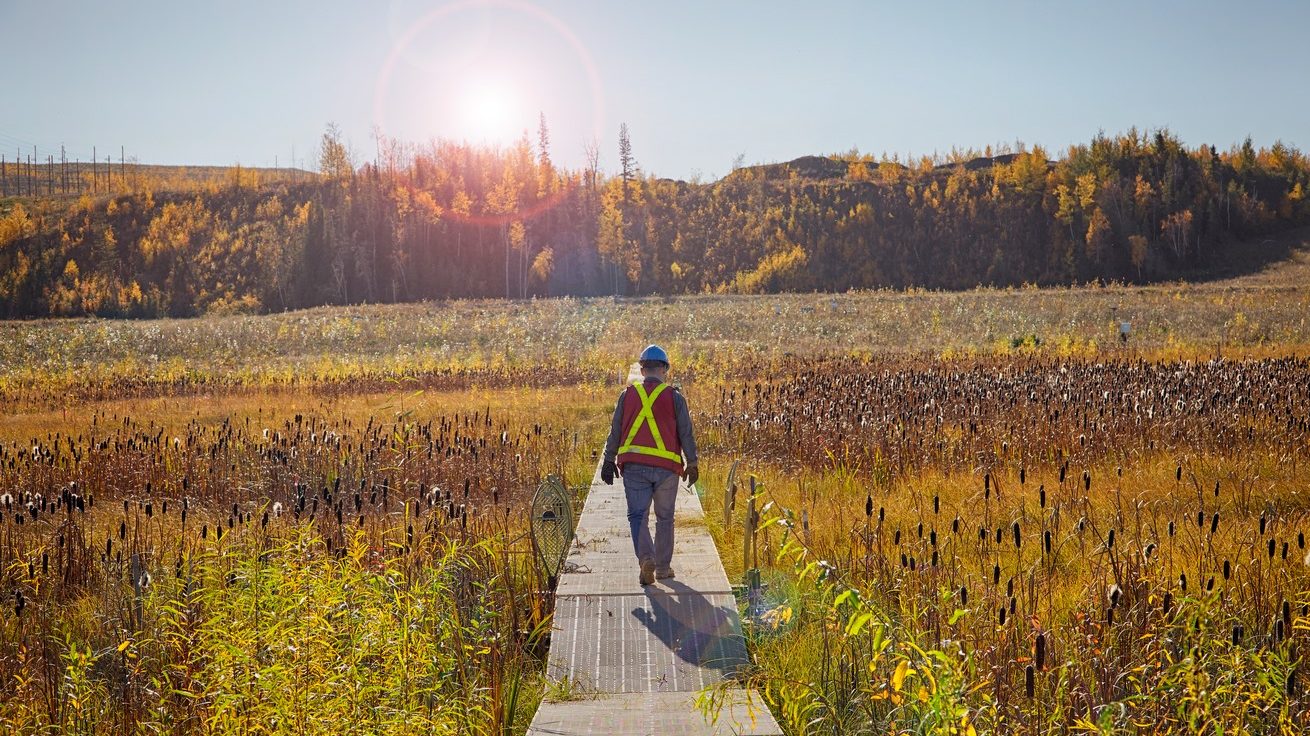Worker at a constructed wetland reclamation project at Suncor Energy's oil sands base mine. Photo courtesy Suncor Energy