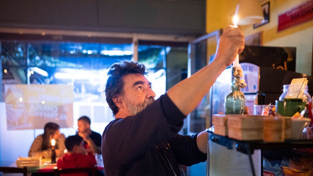 Remo Benzi, owner of the Hop brewery lights candles for the candlelit dinner at "Hop-Mangiare di Birra" restaurant and brewery on October 4, 2022 in Alessandria, Italy. Every Tuesday evening, since a month, the restaurant turns off the lights and lights the candles as a reaction to the high energy prices. The Italian Business Confederation estimates that nearly 120,000 companies are threatened with bankruptcy due to energy price hikes. Getty Images photo