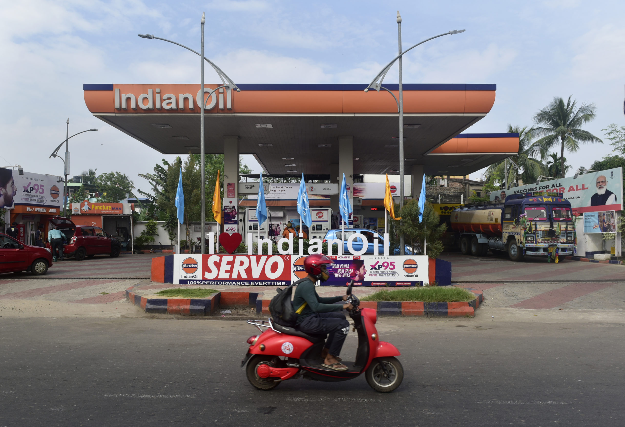 A rider in his scooter passes by an Indian Oil Crop. gas station in Kolkata, India. Getty Images photo