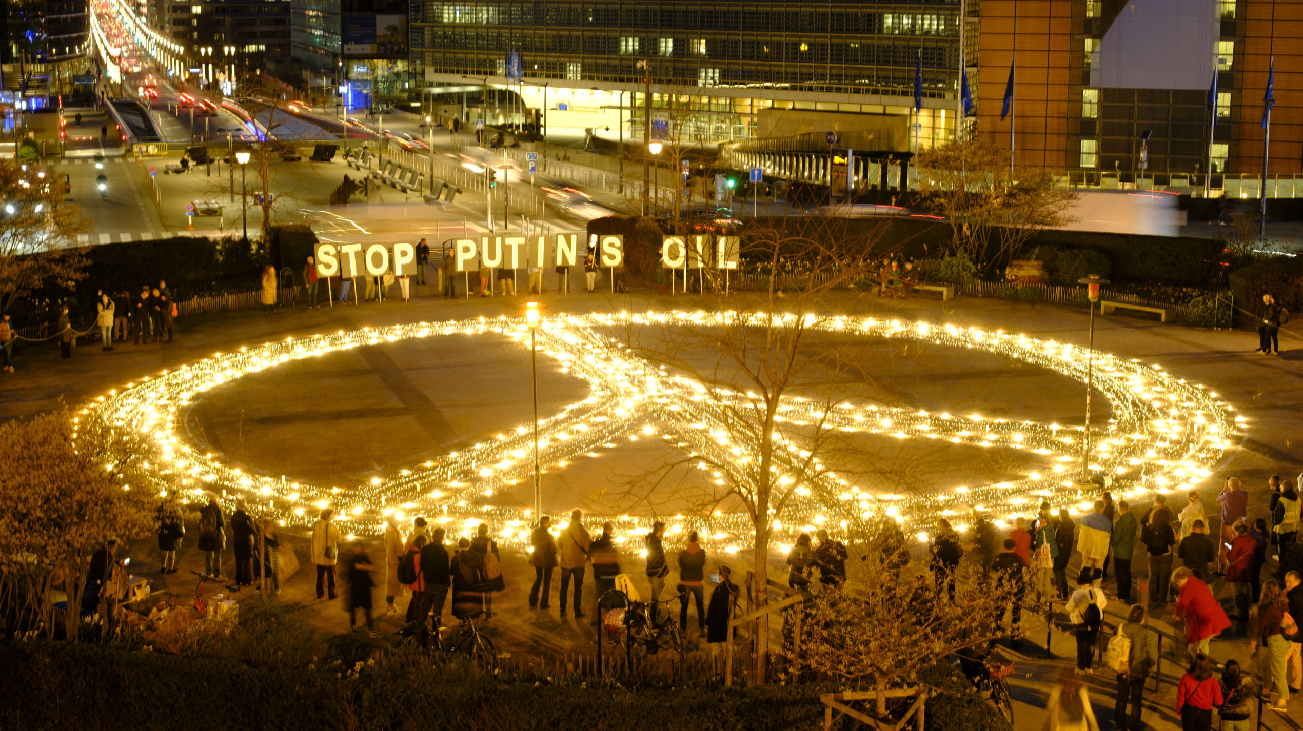 Young Ukrainians demonstrate with a giant peace sign and 'Stop Putin's oil ' in front of the Jusutus Lispsius; the EU Council building and the Berlaymont, the EU Commission building on March 22, 2022 in Schuman Roundabout, Brussels, Belgium. Getty Images photo